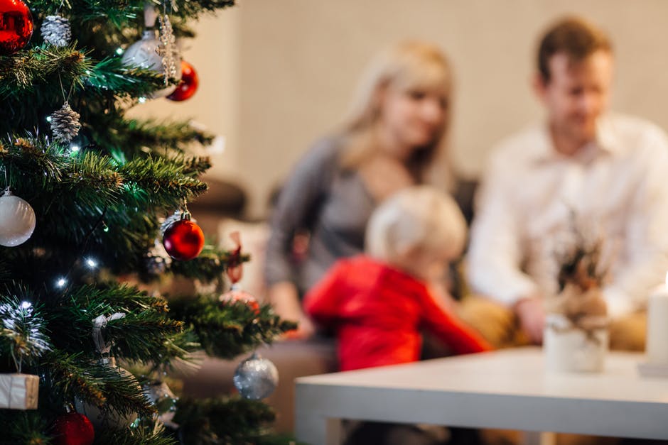 christmas tree and family in background