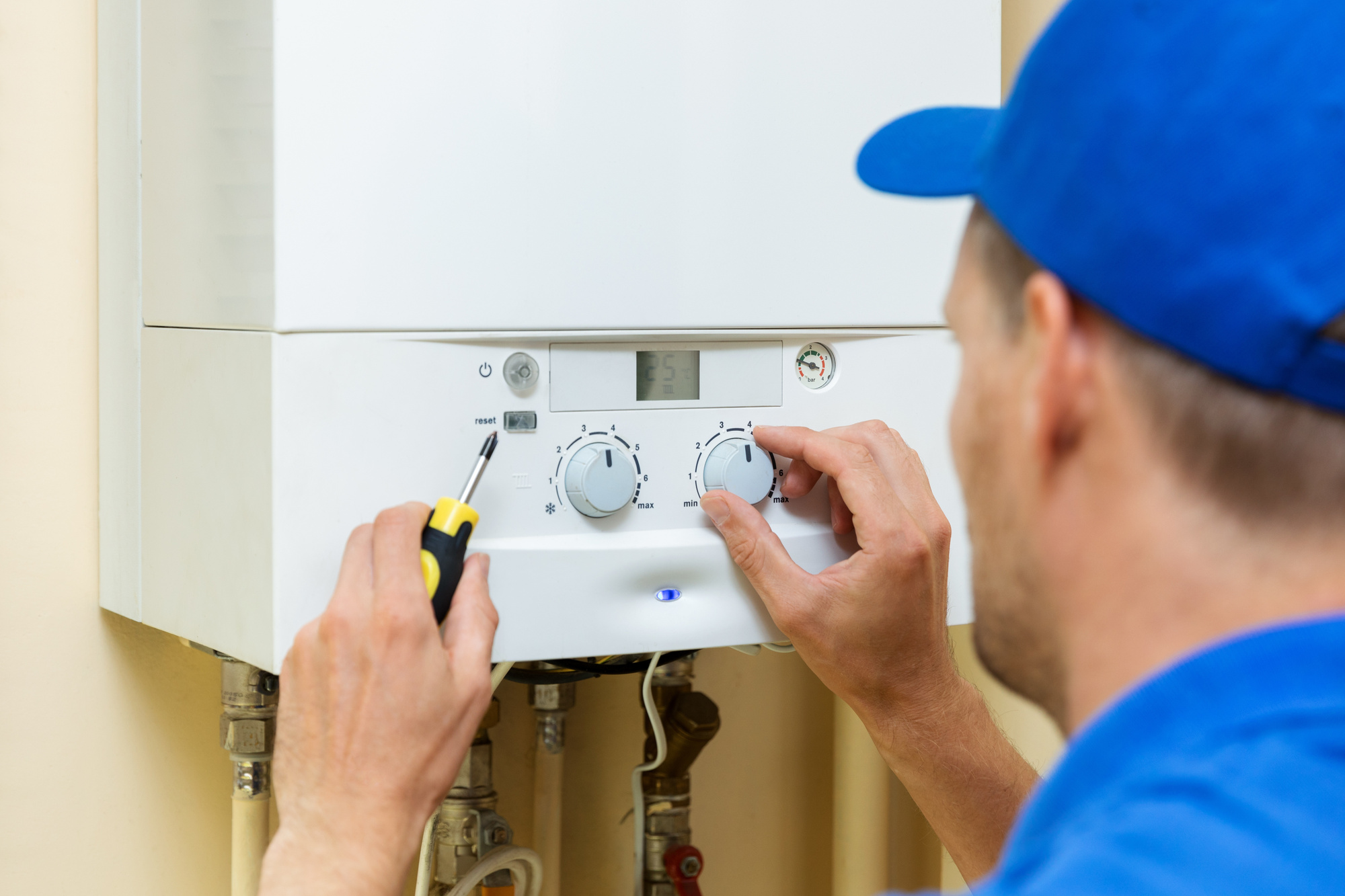 Person Fixing a Furnace Temperature Control