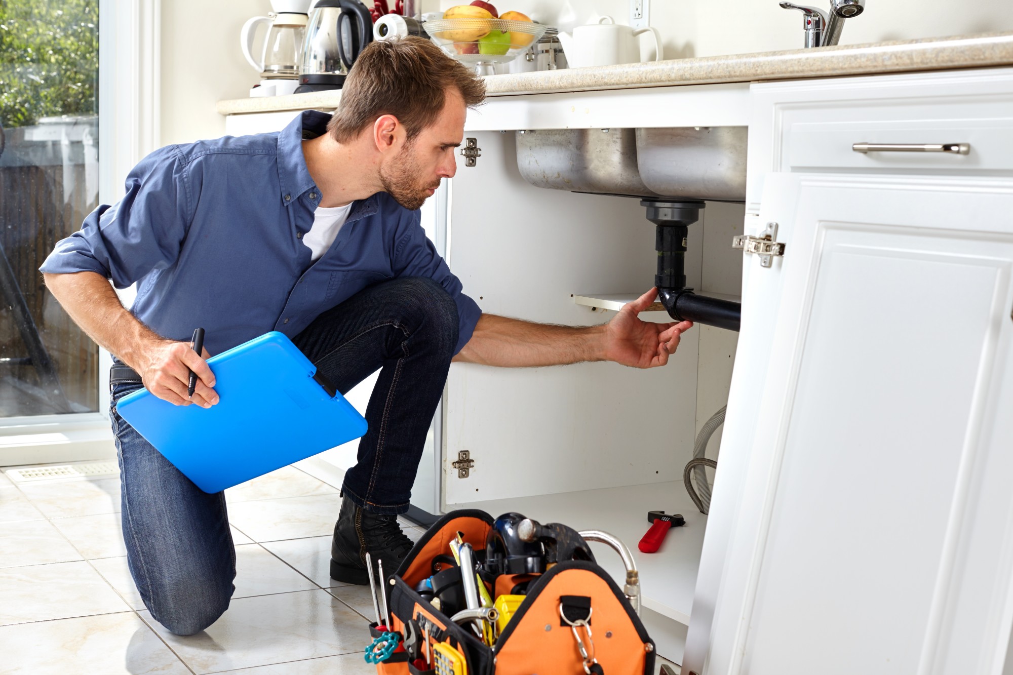 Plumber Fixing a Sink Piping