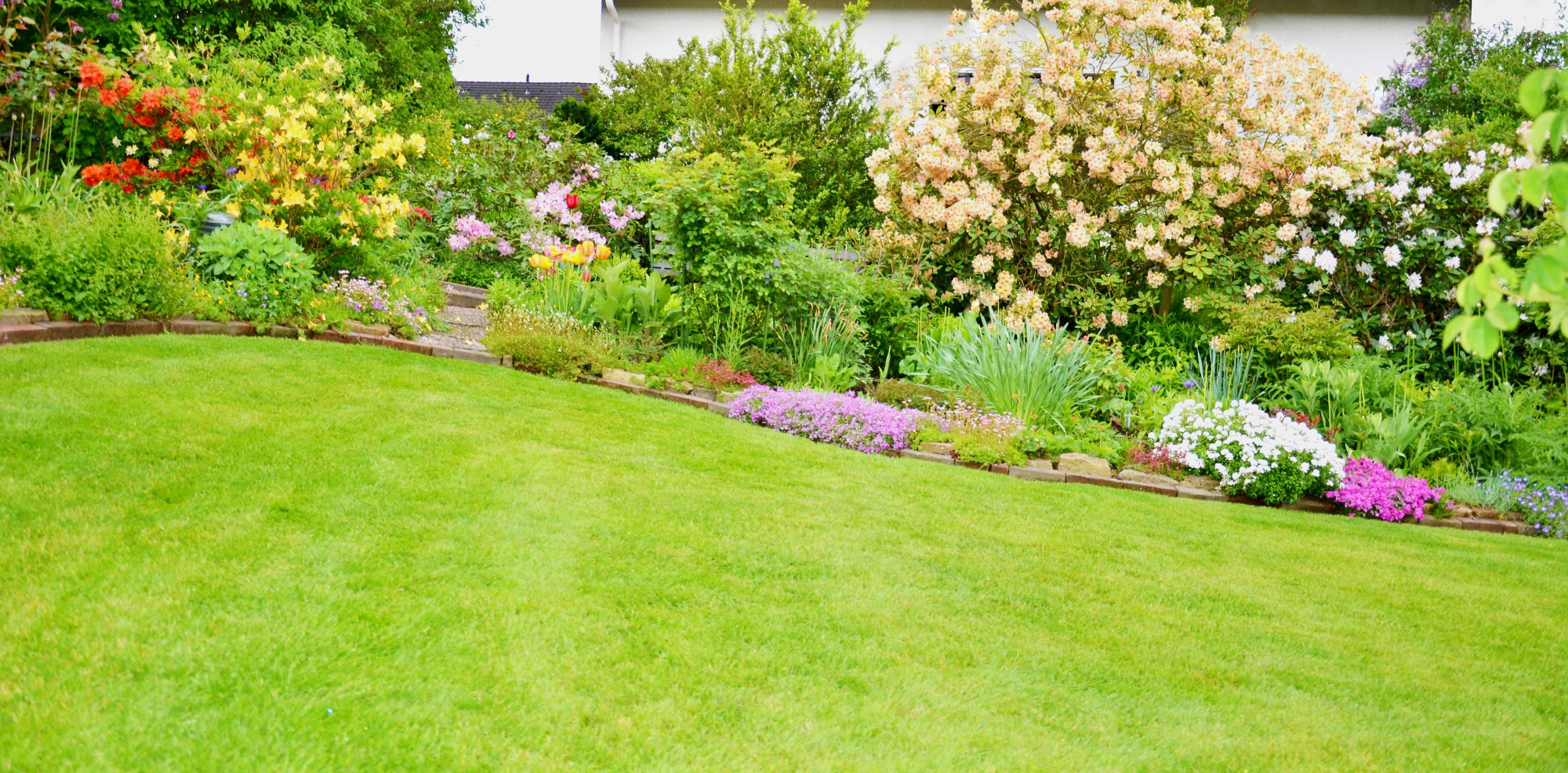 Grassy Lawn with a Garden in the Back