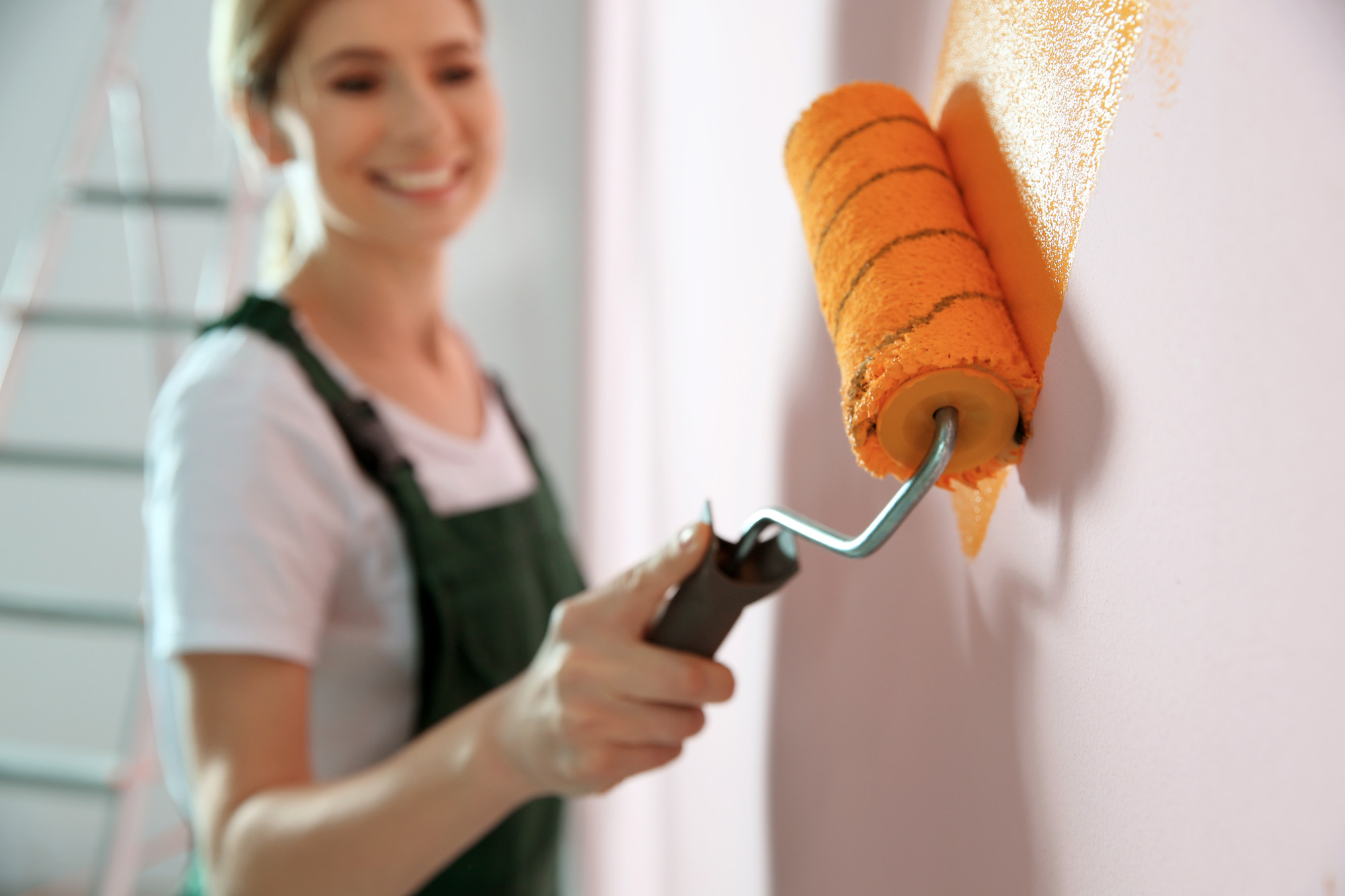 Woman Painting a Wall