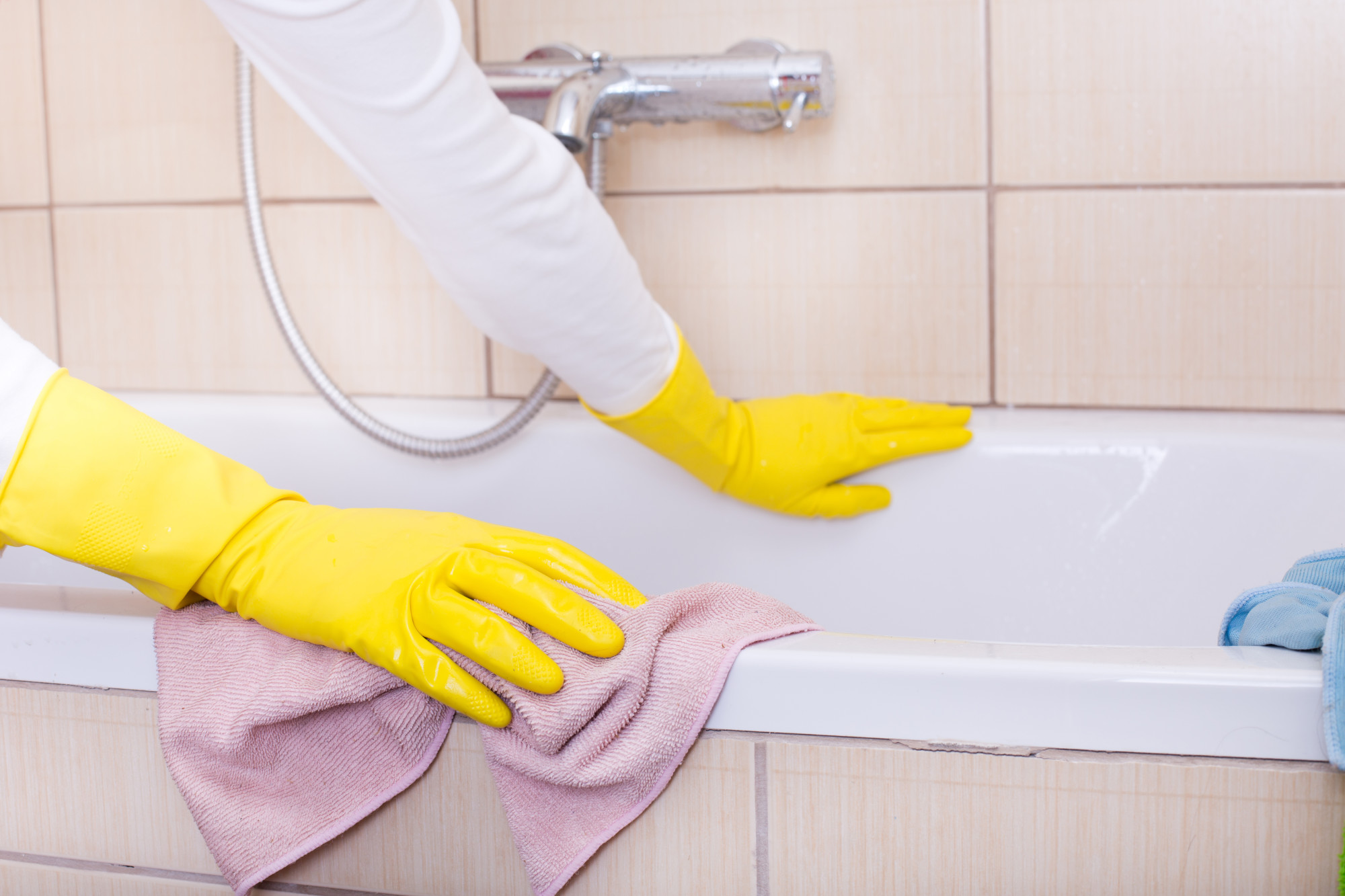 Person Cleaning a Bath Tub